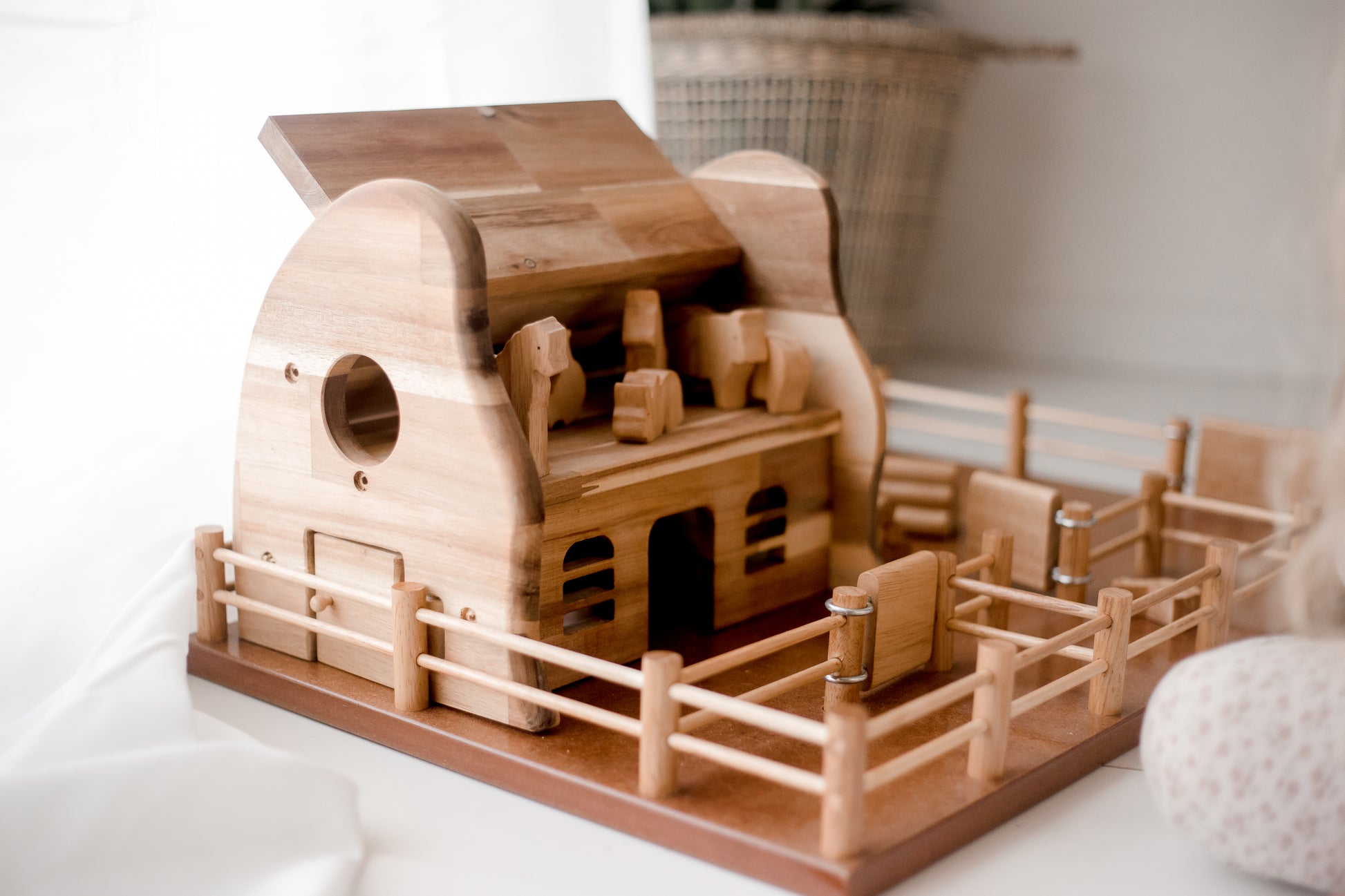 Sturdy wooden Farm Barn playset invites kids to enjoy imaginative rural adventures with toy animals and tractors.