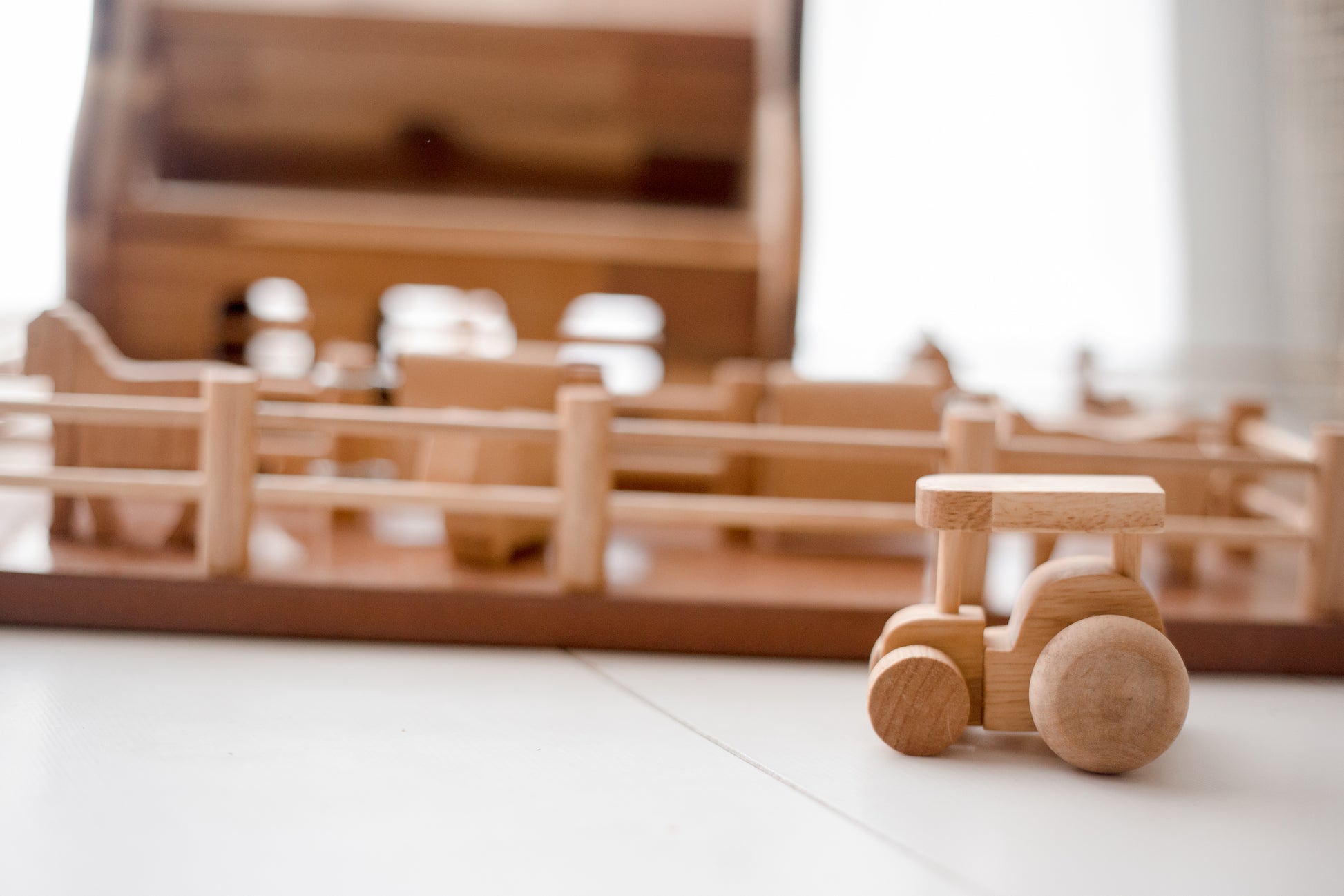 Rustic wooden Farm Barn playset with tractor, perfect for inspiring imaginative rural adventures for kids.